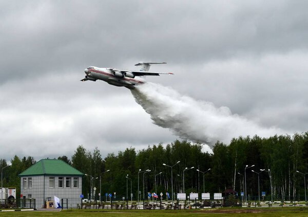  Fire-fighting aircraft IL-76TD drops water over the range of the Noginsk rescue center EMERCOM of Russia at the International Salon "Integrated Security-2017".