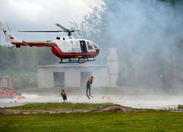  Rescuers-scuba divers are dropped from the BO-105 helicopter "Tsentrospasa" EMERCOM of Russia on the range of the Noginsk rescue center.