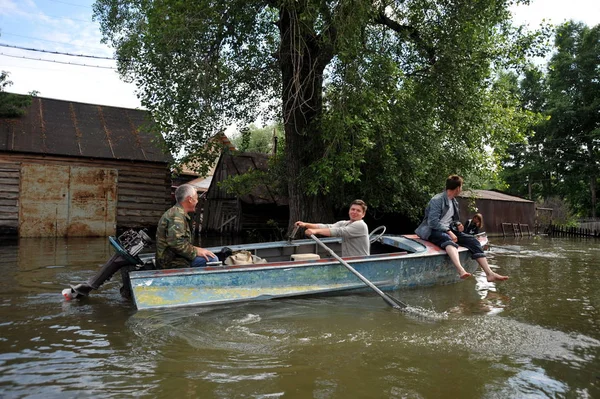 Locals move around the streets by boat. The Ob river, which came out of the banks, flooded the outskirts of the city. — Stock Photo, Image