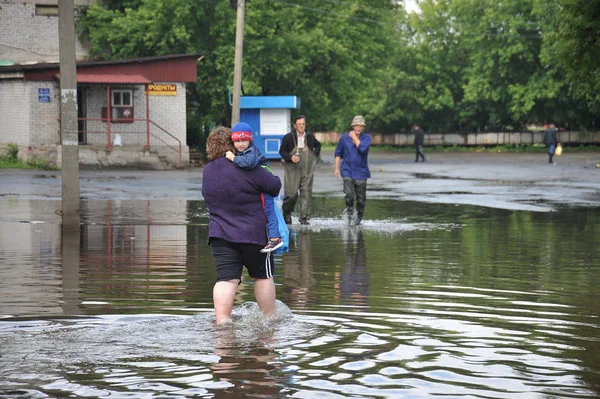 Місцеві жителі переміщення по вулицях під час повені. Обі, який вийшов з банками, затоплені околиці міста. — стокове фото