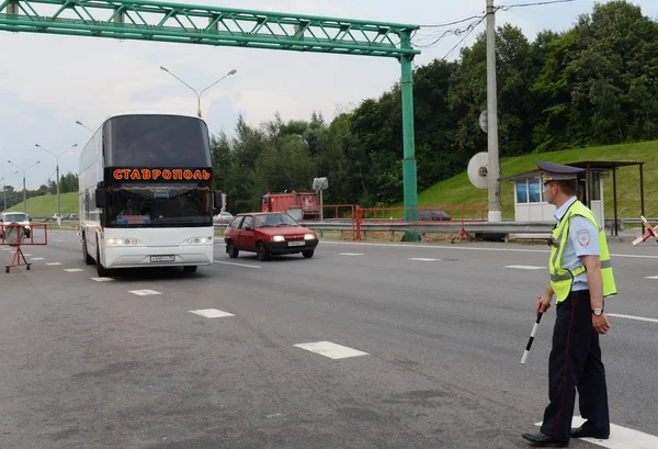 L'inspecteur de la patrouille de police routière arrête le bus interurbain pour vérifier . — Photo