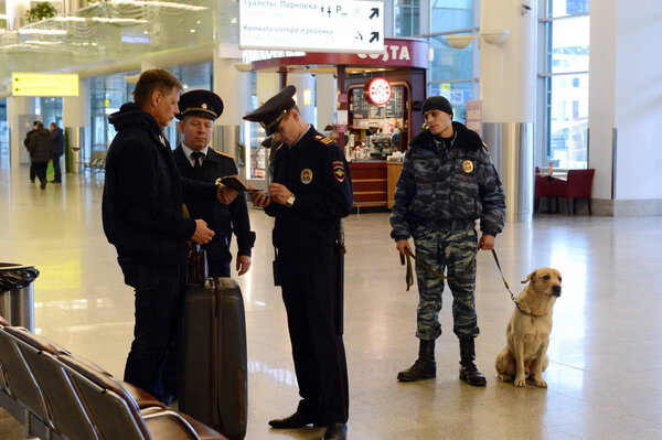  Transport police officers check the documents of passengers at Sheremetyevo international airport in Moscow