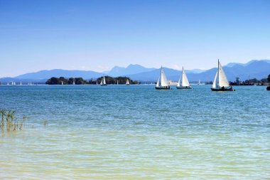Floating yachts on lake Chiemsee clipart