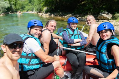 Close up of rafting team goes down the river on the beautiful su