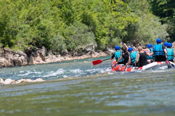 Rafting team goes down the river on the beautiful sunny day. Bac