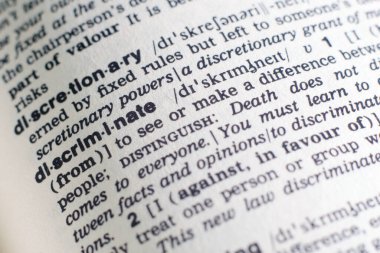 İngilizce sözlükte ayrımcı bir sözcüğe yakın plan (seçici odak)