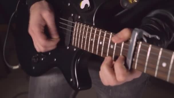 Gitarist met zwarte muziekinstrument op het concert of de try-out binnenshuis — Stockvideo