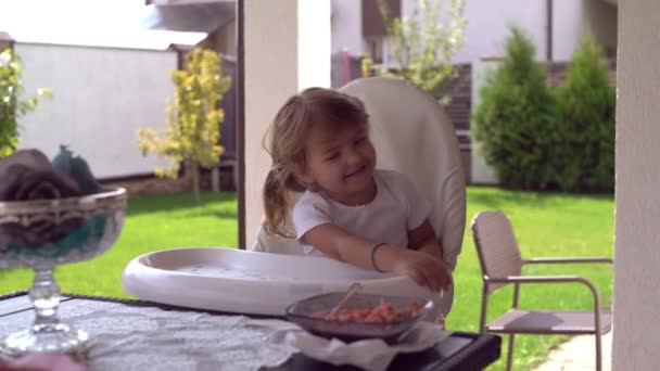 Bambino carino seduto sul seggiolone per l'alimentazione — Video Stock