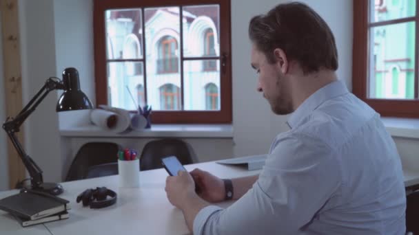 Designer utilisant le téléphone à la maison ou au bureau . — Video