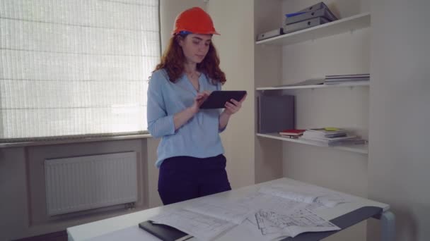 Woman architect with blueprint architectural plan. — Stock Video