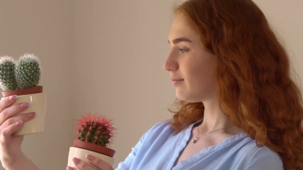 Redheaded female contemplating flower — Stock Video