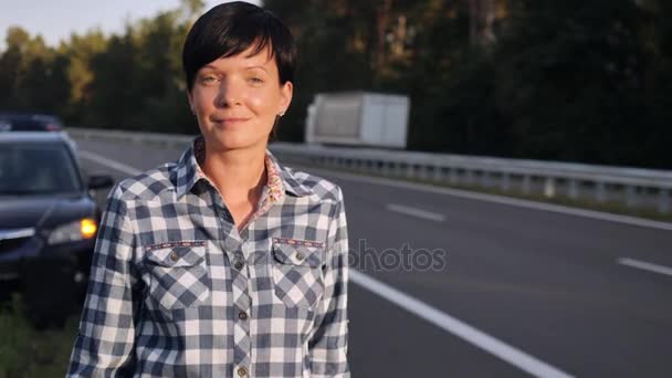 Mujer al lado de la carretera . — Vídeo de stock