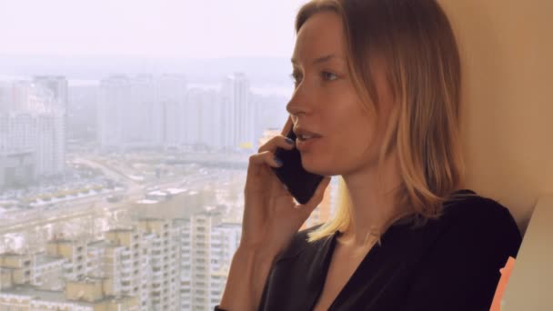 Young lady talking with friend by smartphone — Stock Video