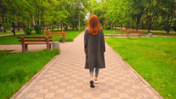 Назад вид женщина прогулки по улице образ жизни в весеннем городе — стоковое видео