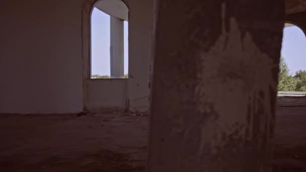 Brunette with long hair in suit in deserted forsaken house — Stock Video