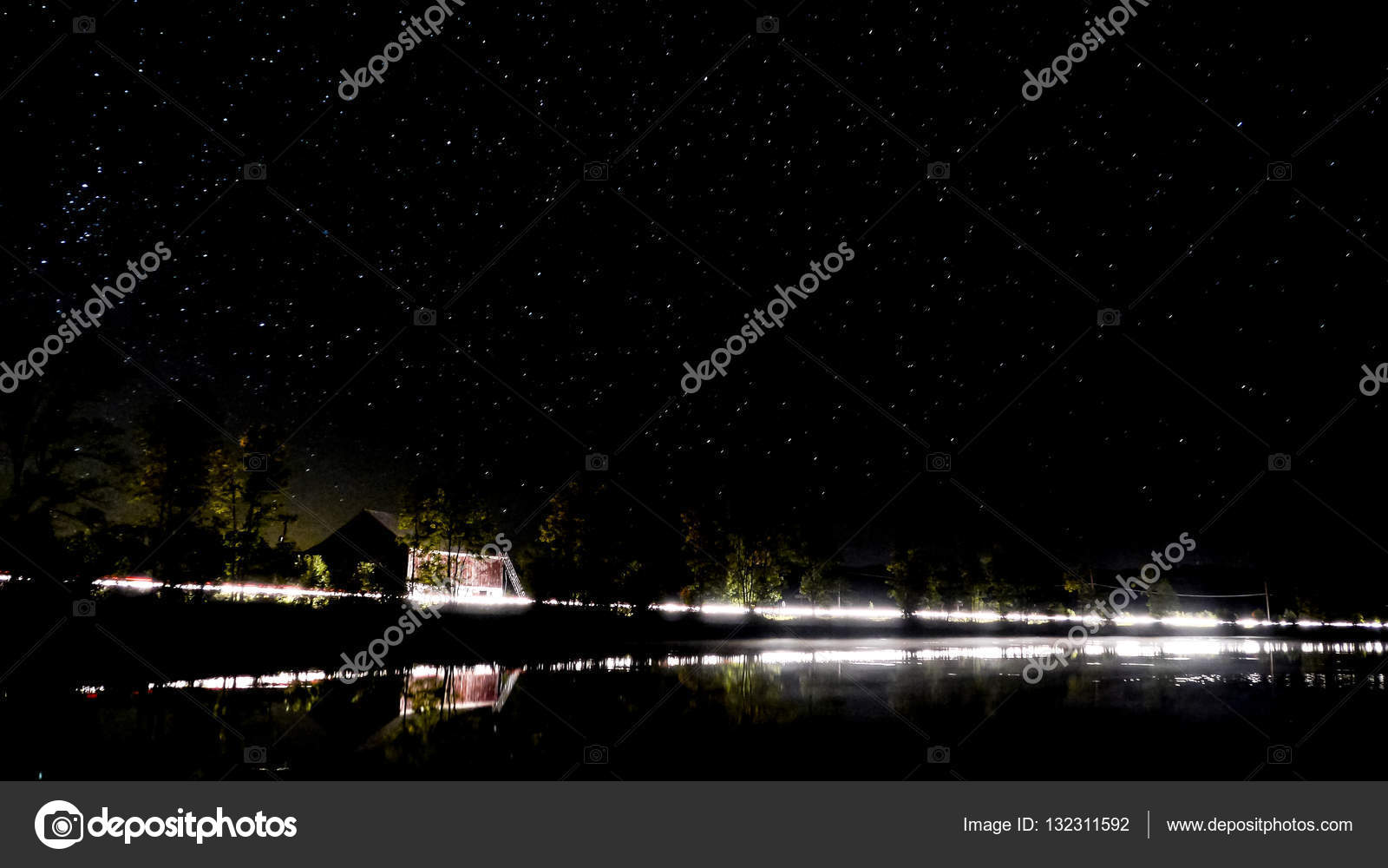 Night Scene From A Lake In Canada With A Red Barn And Lights From