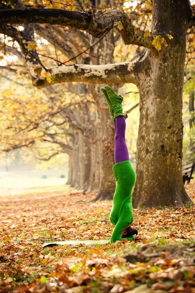 woman practice head stand outdoor