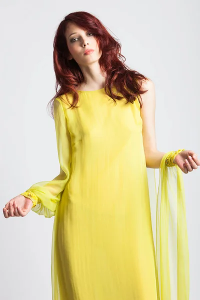 Red-haired girl in long elegant yellow dress — Stock Photo, Image