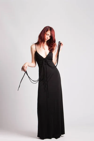 Red-haired girl in long evening black dress — Stock Photo, Image