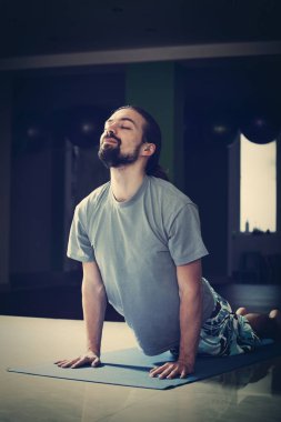 genç adam kapalı yoga yaparken