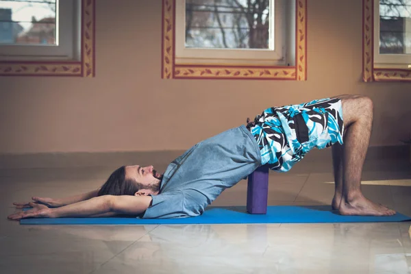 Young man doing yoga  indoor — Stock Photo, Image