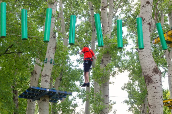 Человек в парке приключений на вершине дерева — стоковое фото