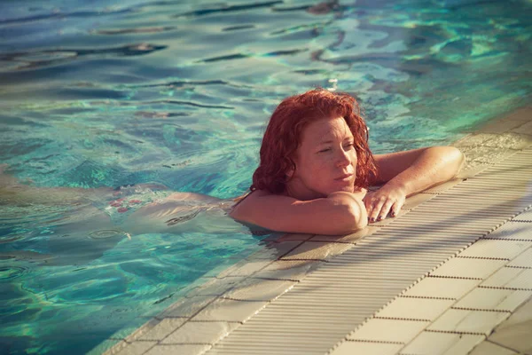 Redhead freckled young woman in pool real people concept — Stock Photo, Image