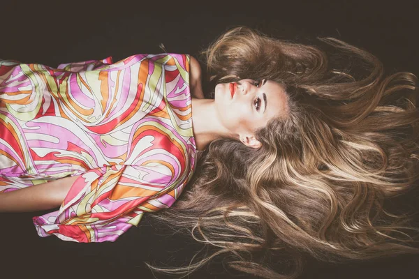 Young woman with very long blonde hair lie down studio shot — Stock Photo, Image