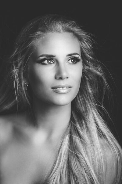young blonde woman beauty portrait in black and white studio