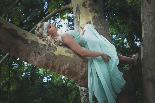 Bella giovane donna in abito romantico si trovano su albero giorno d'estate — Foto Stock