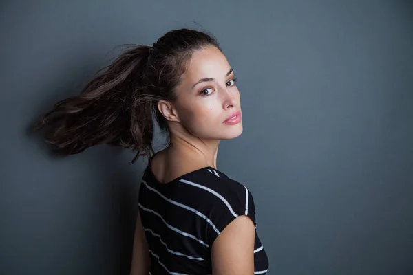 Young pretty woman portrait with ponytail studio shot — Stock Photo, Image