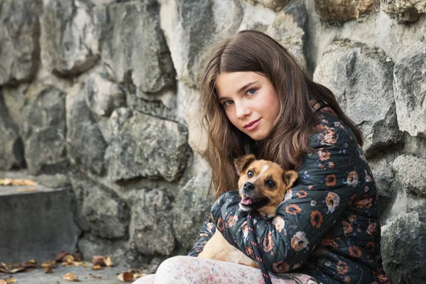 Cute teen girl hugging her new pet adopted friend  dog from resc — Stock Photo, Image