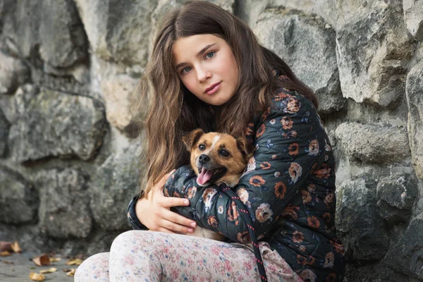 Beautiful teen girl hugging her new pet adopted friend  dog from — Stock Photo, Image