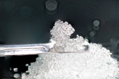               Chemical powder from the chemistry kit with macro lens photographed in studio                  clipart