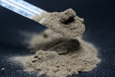               Chemical powder from the chemistry kit with macro lens photographed in studio                  clipart