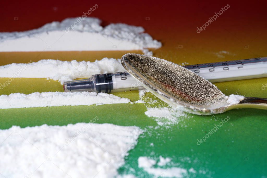 Flour that should look like a white drug with macro lens photographed in front of colorful gradient in the studio