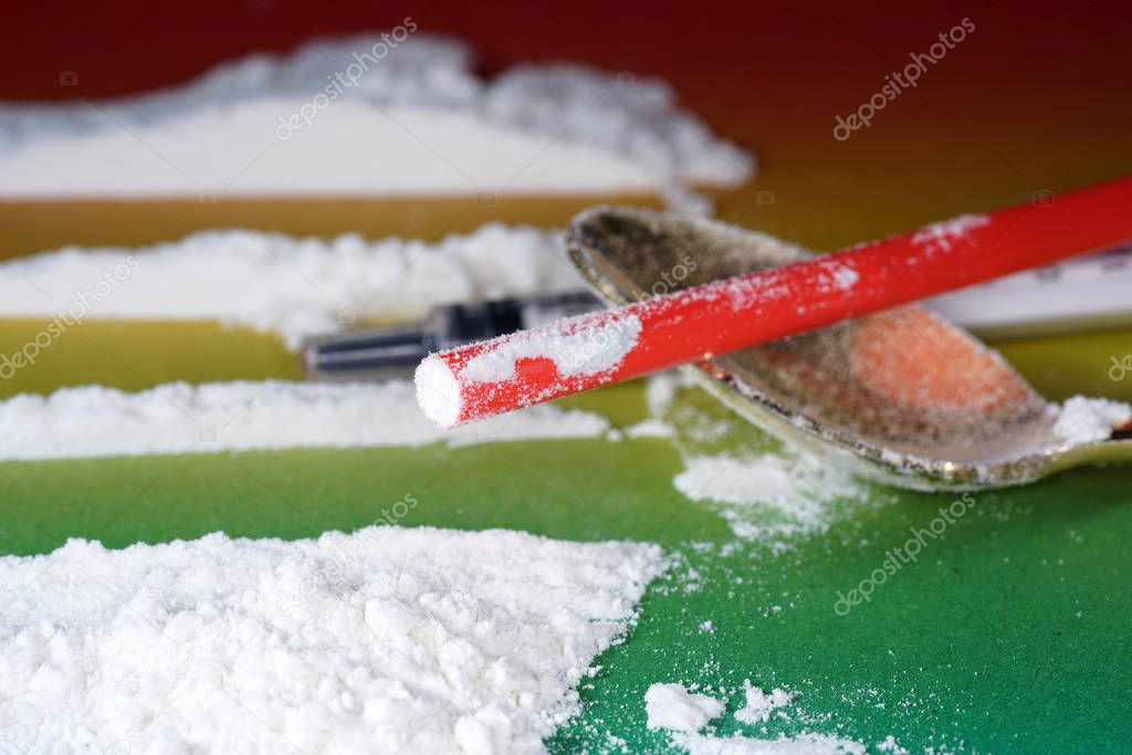 Flour that should look like a white drug with macro lens photographed in front of colorful gradient in the studio
