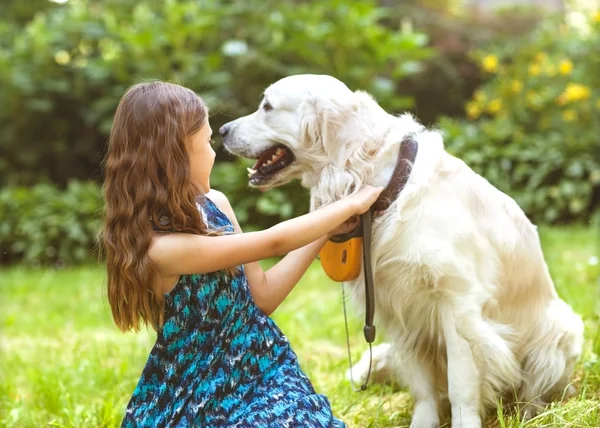 Little girl in the park their home with a dog — Stock Photo, Image
