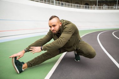 adam sokakta stadyum üzerinde egzersiz yapıyor