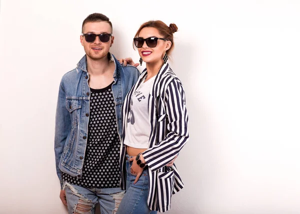 beautiful fashion couple with sunglasses on a white background. Vogue Style