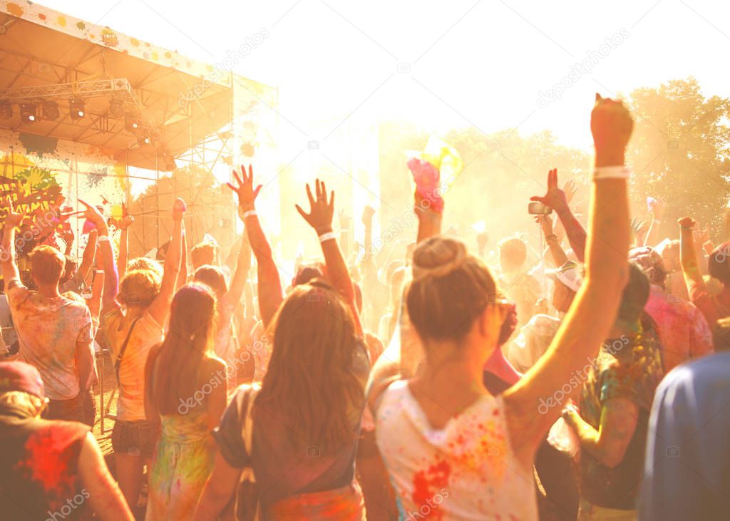 a crowd of people celebrating the Holi festival