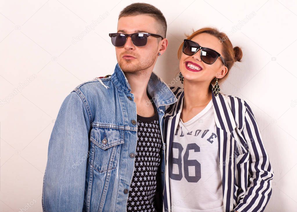 beautiful fashion couple with sunglasses on a white background. Vogue Style