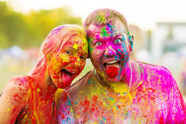 Guys with a girl celebrate holi festival