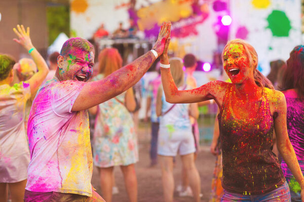 Guys with a girl celebrate holi festival