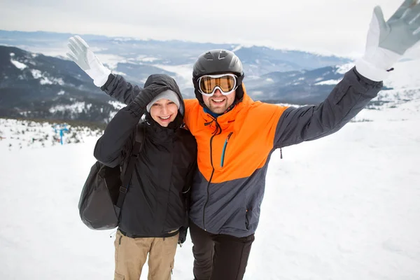 couple in love on top of the mountain in winter