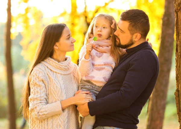 Family walk in the park, happy at sunset — Stock Photo, Image
