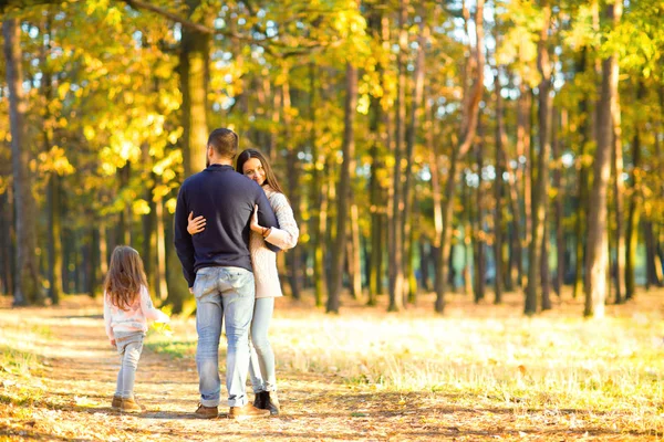 Mom and dad with daughter at sunset playing Stock Picture