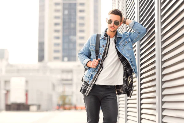 Fashion guy posing in sunglasses on sunset — Stock Photo, Image