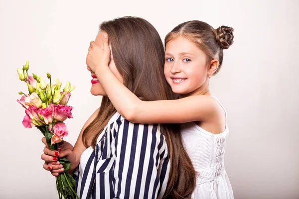 Figlia dona fiori alla madre nel giorno della madre — Foto Stock