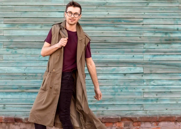 Modemann mit Brille posiert in blu an einer Holzwand — Stockfoto